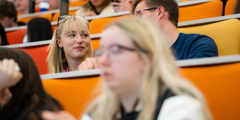 Two students in lecture and discussion